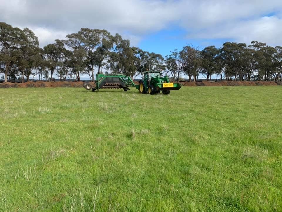 Tractor and compost turner on a farm paddock