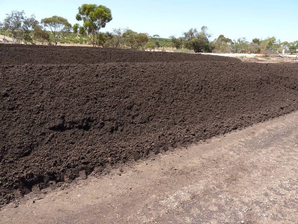 Finished compost windrow on a commercial composting pad